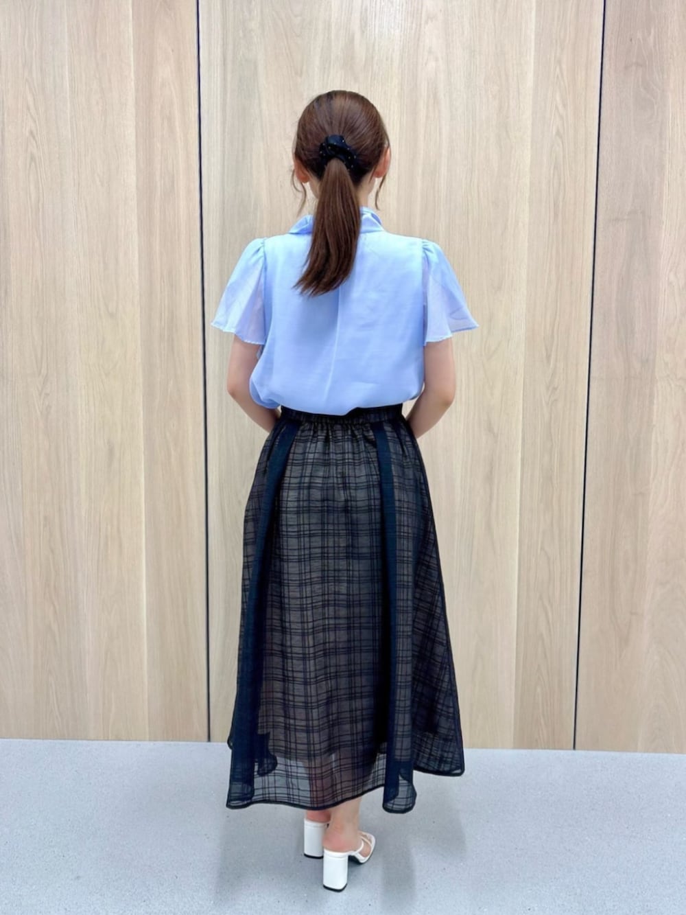 ブルー系のシャツ/ブラウス、ブラック系のスカートを着用したレディースの夏コーディネートの3枚目の写真