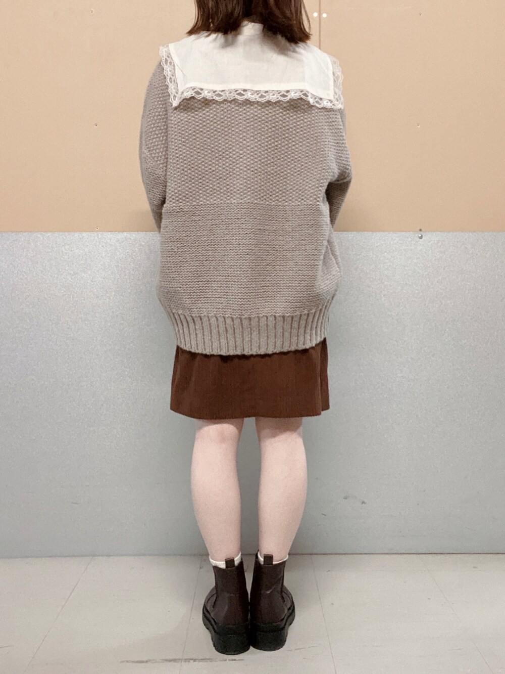 ブラウン系のブーツ、ベージュ系のショルダーバッグ、ベージュ系のカーディガン/ボレロを着用したレディースの秋コーディネートの3枚目の写真