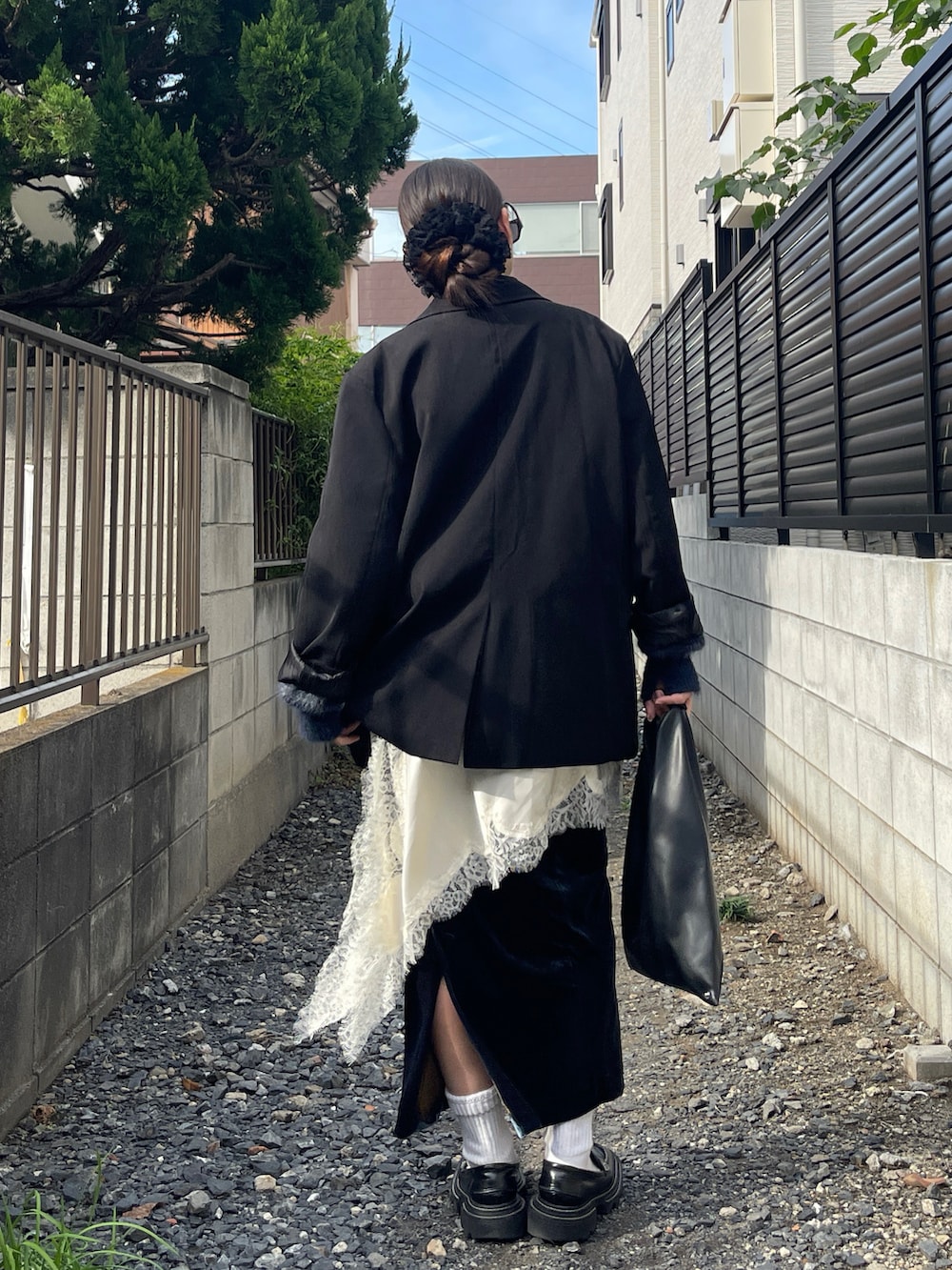 ブルー系のニット/セーター、ブラック系のローファー、ブラック系のトートバッグを着用したレディースの秋コーディネートの4枚目の写真