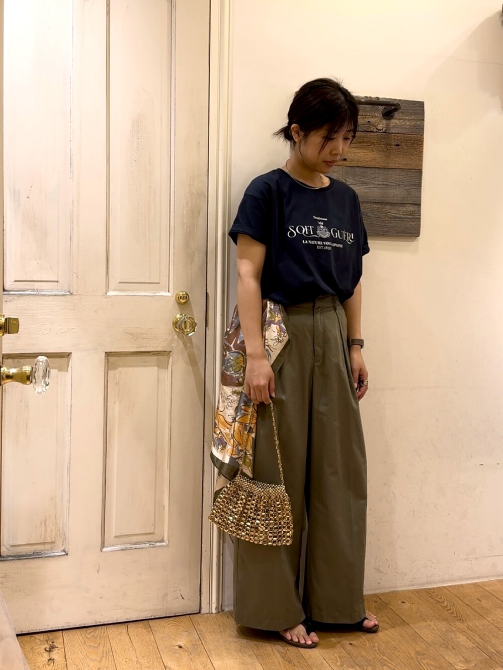 ブルー系のTシャツ/カットソー、ゴールド系のハンドバッグ、グリーン系のその他パンツを着用したレディースの春コーディネートの2枚目の写真