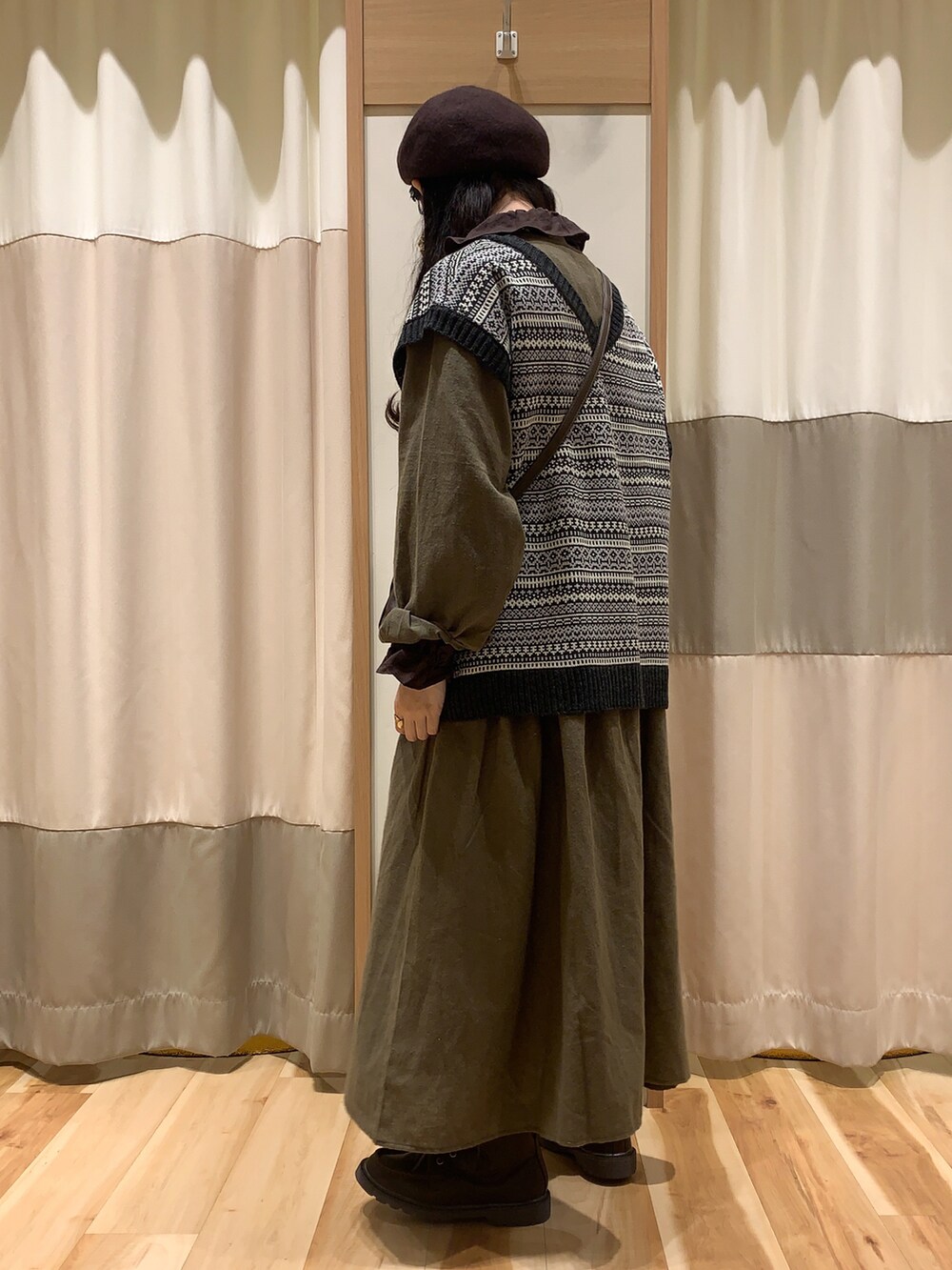 ブラック系のベスト、ブラウン系のショルダーバッグ、ブラウン系のシャツ/ブラウスを着用したレディースの秋コーディネートの4枚目の写真