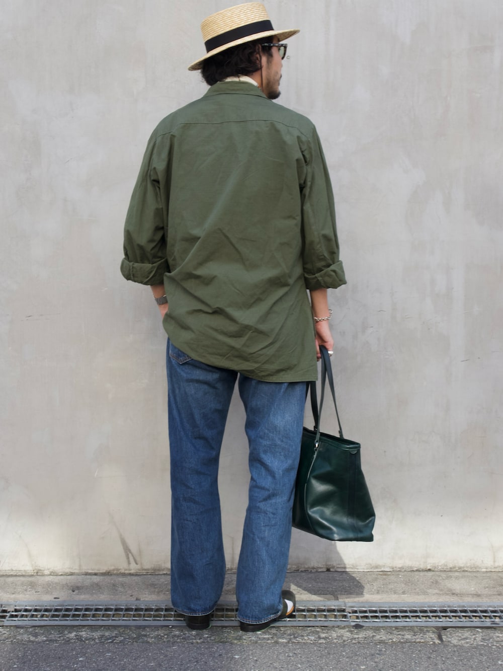 グリーン系のトートバッグ、グリーン系のサンダルを着用したメンズの夏コーディネートの3枚目の写真