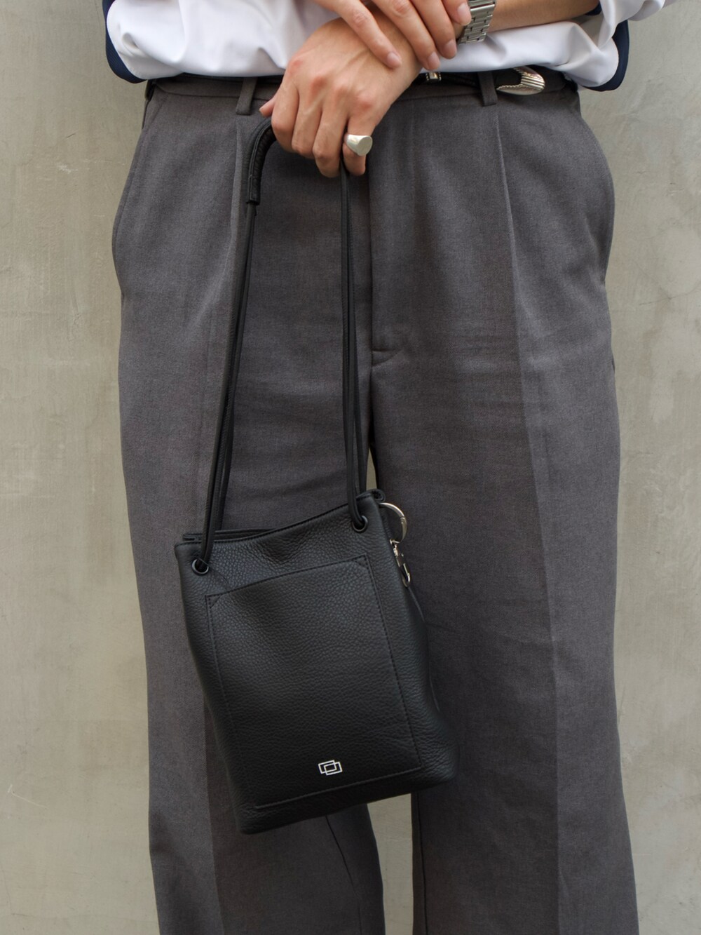 ブラック系のトートバッグ、その他のローファーを着用したメンズの夏コーディネートの3枚目の写真