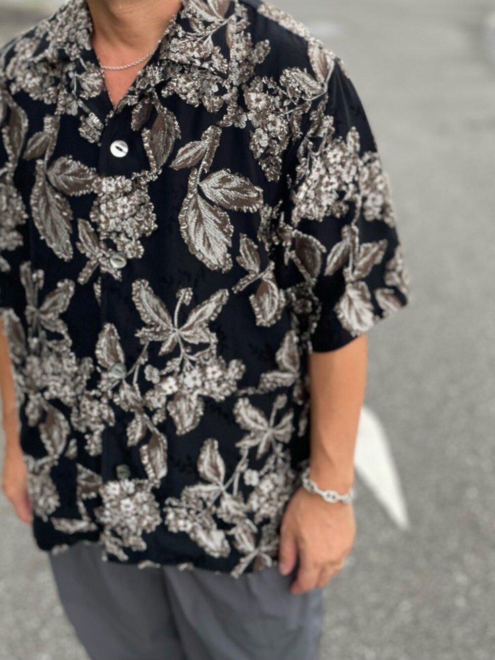 ブラック系のシャツ/ブラウス、グレー系のその他パンツ、ホワイト系のサンダルを着用したメンズの秋コーディネートの2枚目の写真