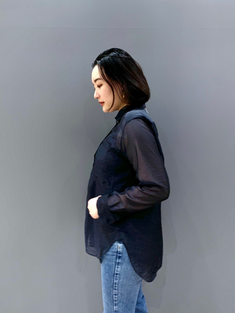 ブルー系のシャツ/ブラウス、ブルー系のデニムパンツ、ブラック系のショルダーバッグを着用したレディースの冬コーディネートの2枚目の写真