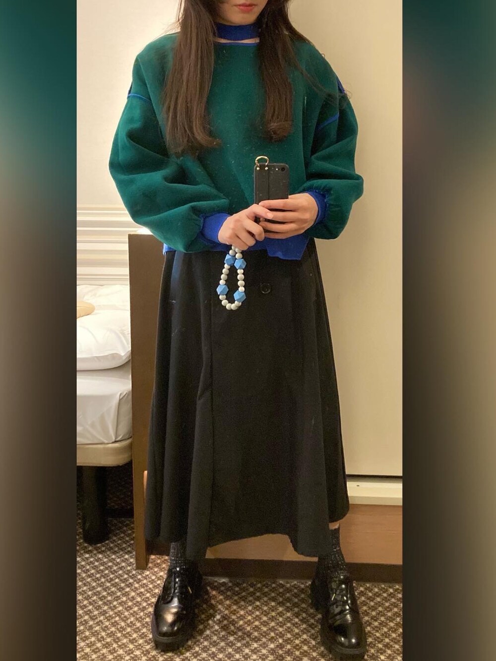 ブルー系のニット/セーター、ブラック系のドレスシューズ、ブラック系のトレンチコートを着用したレディースの冬コーディネートの2枚目の写真