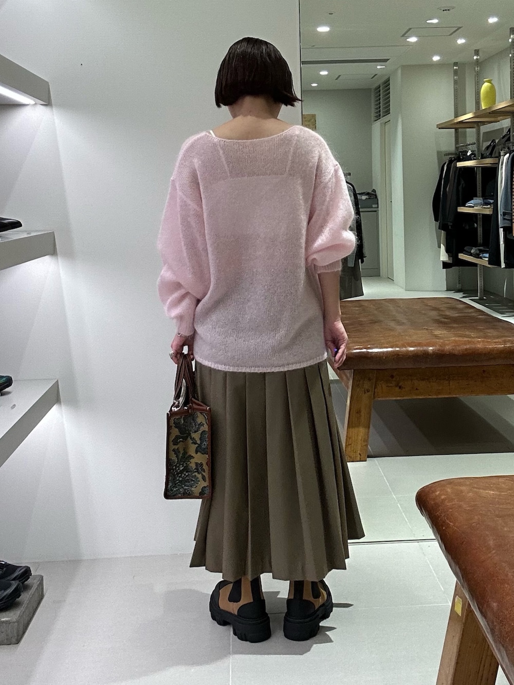 ゴールド系のニット/セーター、ブルー系のスカート、イエロー系のブーツを着用したレディースの秋コーディネートの2枚目の写真