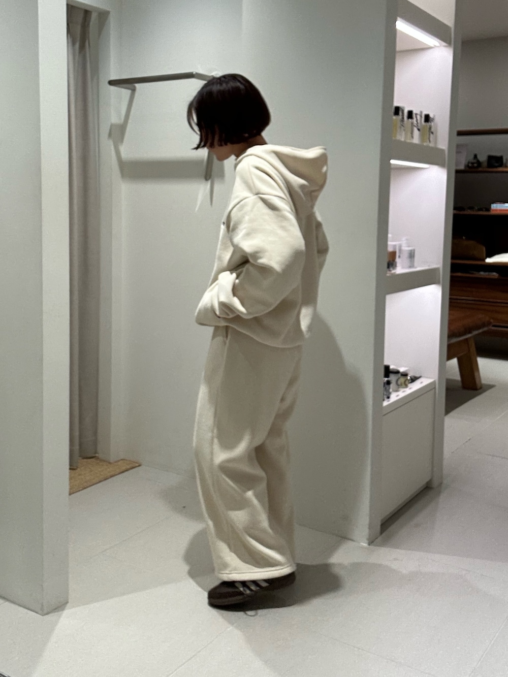 ホワイト系のパーカー、ホワイト系のその他パンツ、ブラウン系のスニーカーを着用したレディースの秋コーディネートの2枚目の写真