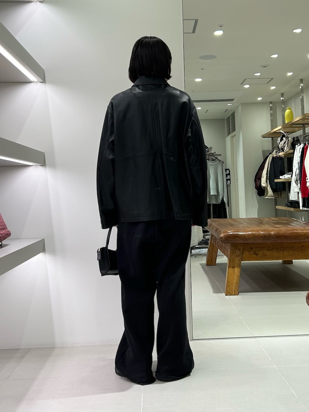 ブラック系のその他アウター、ブラック系のその他パンツ、ブラック系のハンドバッグを着用したレディースの冬コーディネートの3枚目の写真