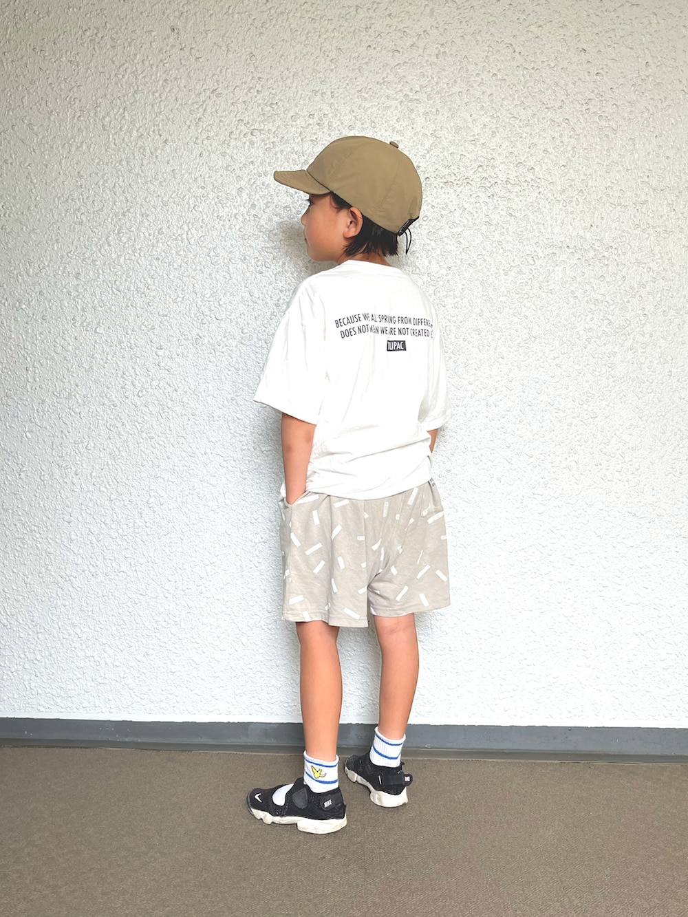 ホワイト系のTシャツ/カットソー、グレー系のその他パンツ、ブラック系のスニーカーを着用したキッズの秋コーディネートの3枚目の写真