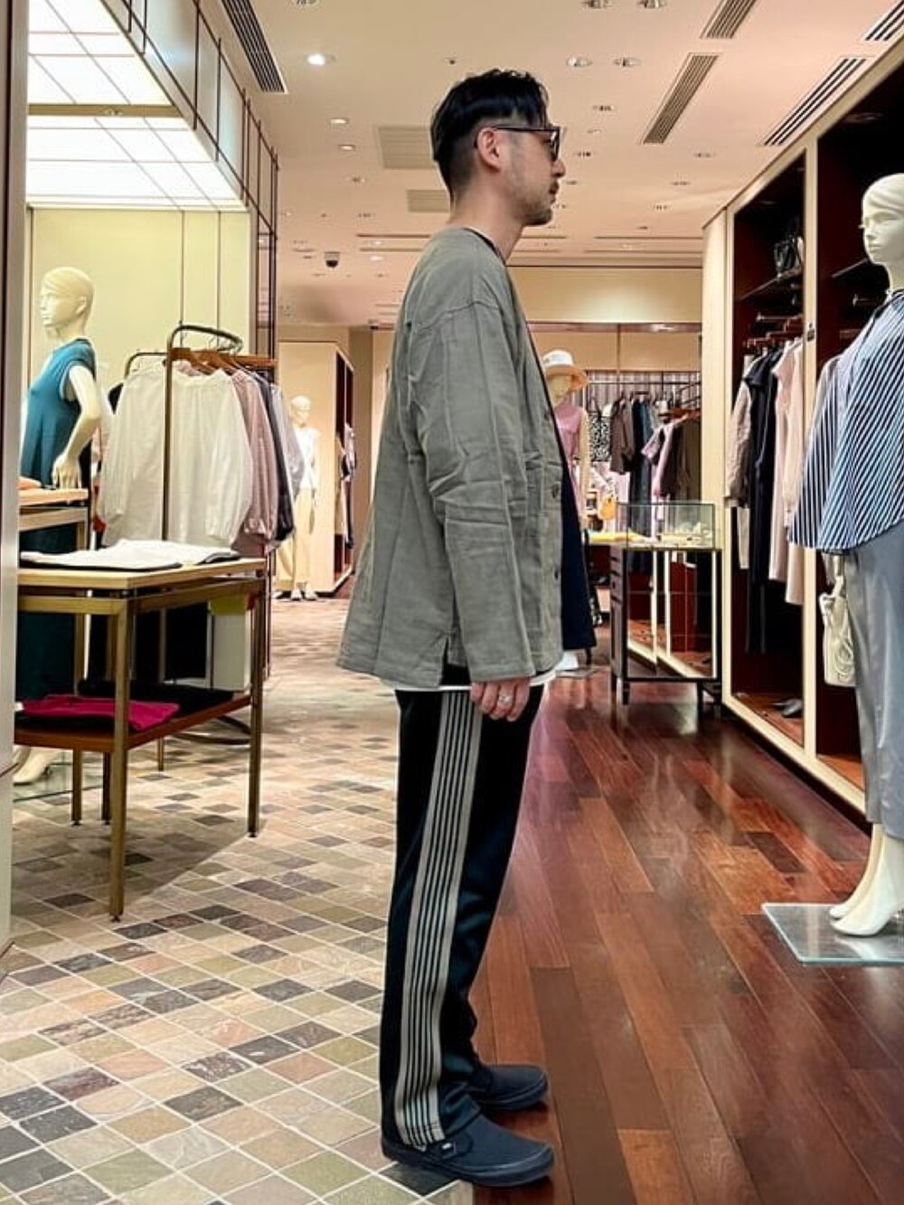 ブラウン系のカーディガン/ボレロ、ブラック系のTシャツ/カットソーを着用したメンズの春コーディネートの2枚目の写真
