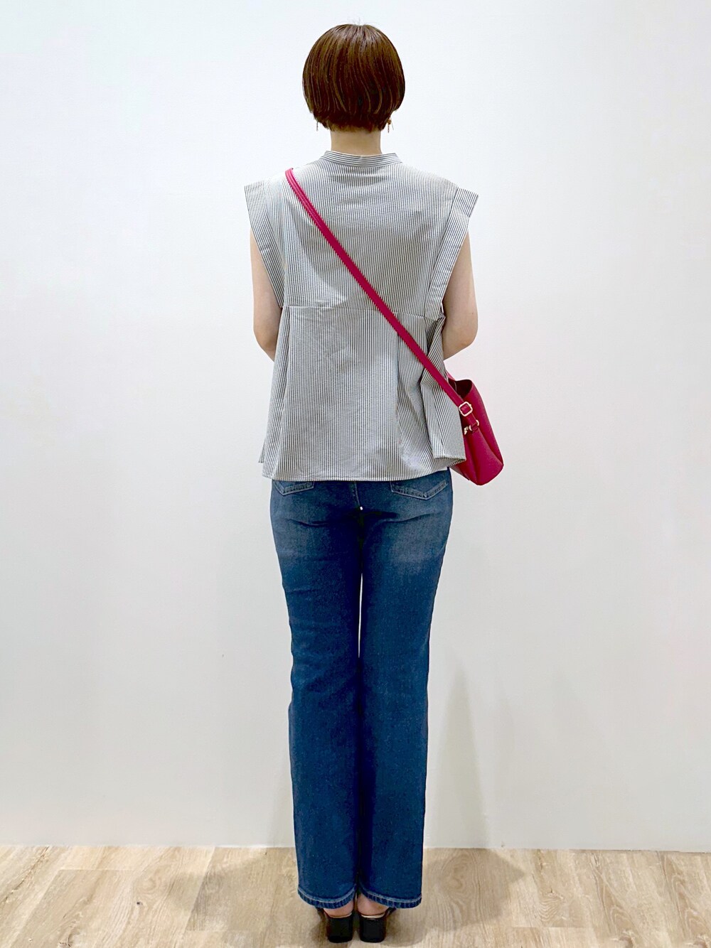 ホワイト系のシャツ/ブラウス、ブルー系のデニムパンツ、ピンク系のショルダーバッグを着用したレディースの夏コーディネートの4枚目の写真