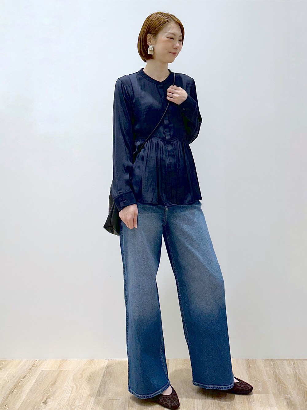 ブルー系のシャツ/ブラウス、ブルー系のデニムパンツ、ブラック系のショルダーバッグを着用したレディースの秋コーディネートの3枚目の写真