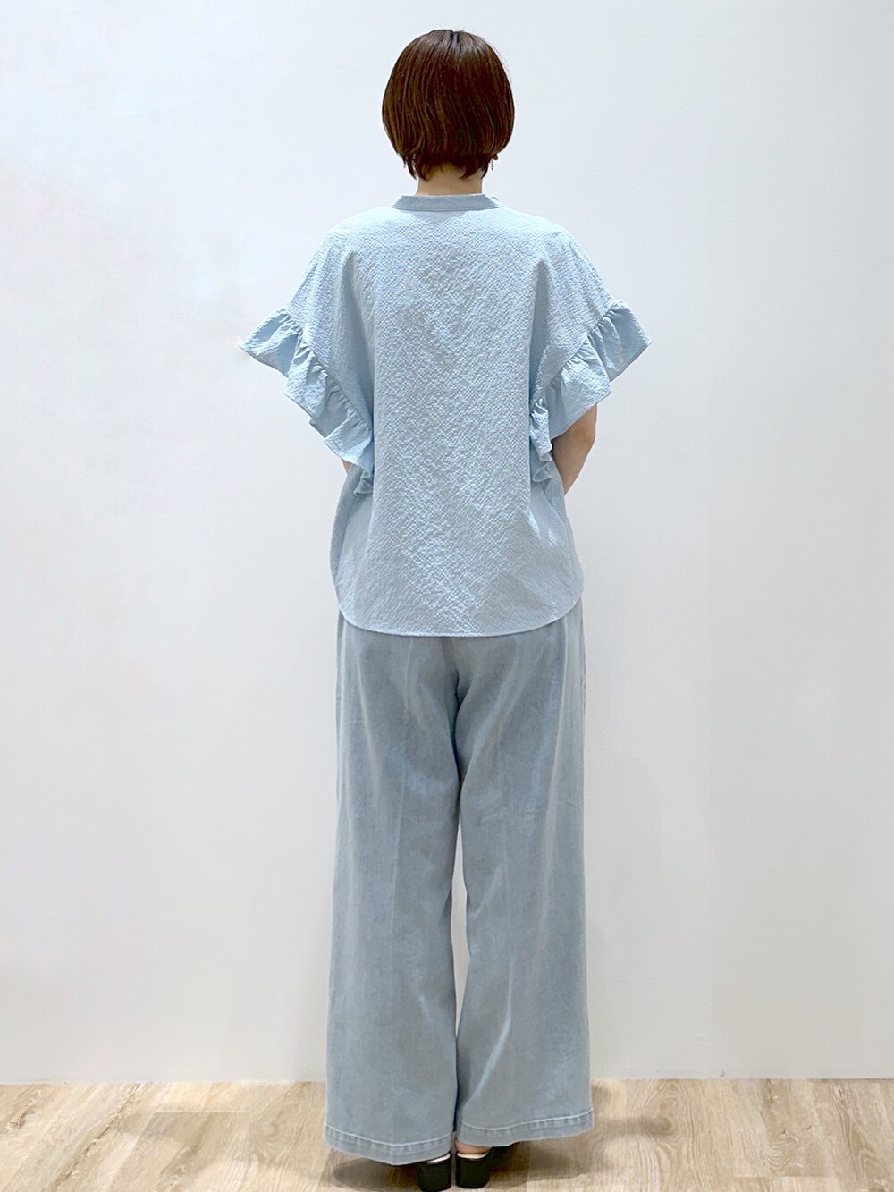 ブルー系のシャツ/ブラウス、ブラック系のタンクトップ、ブルー系のデニムパンツを着用したレディースの夏コーディネートの3枚目の写真