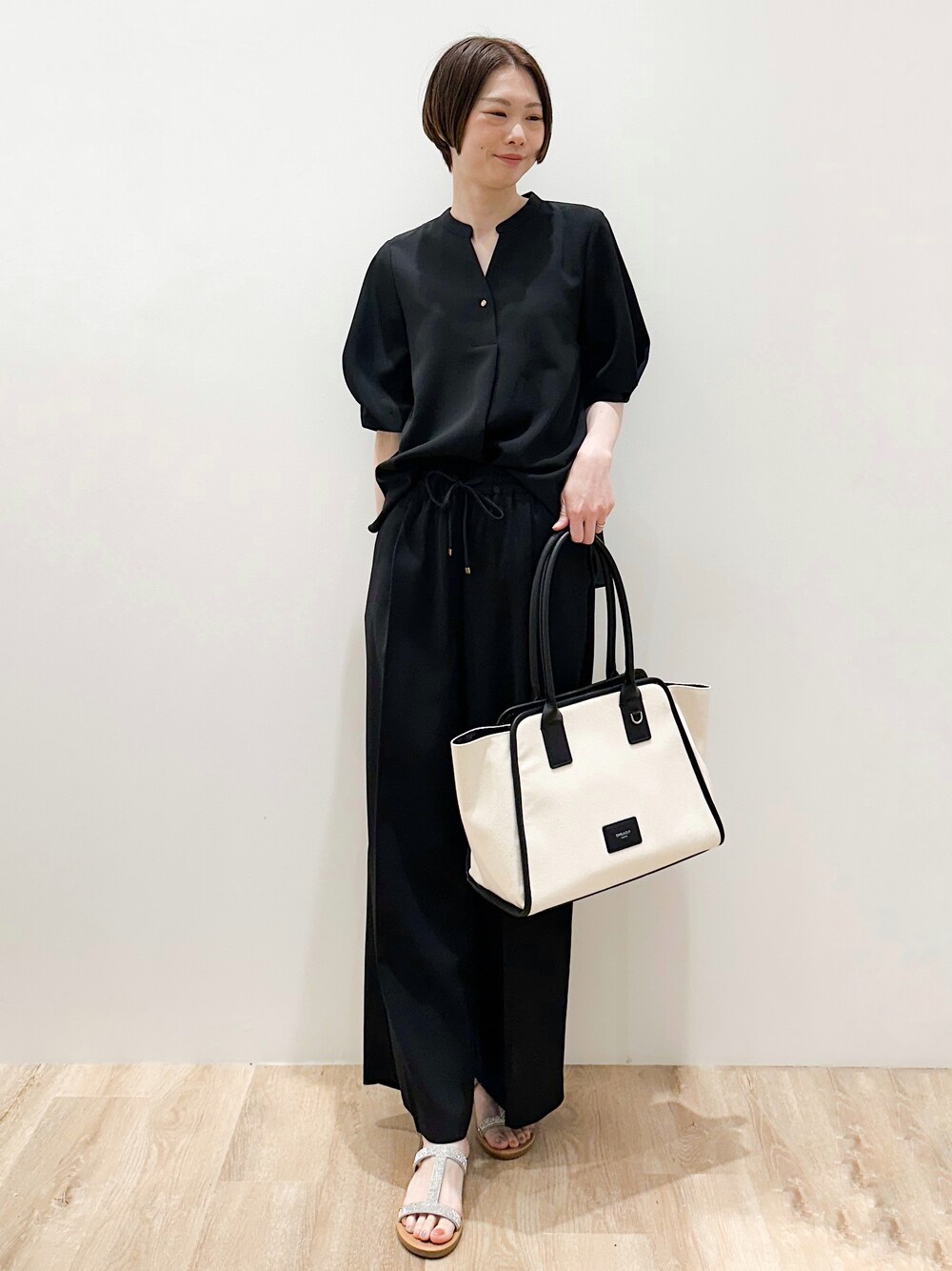 ブラック系のパンプス、ブラック系のシャツ/ブラウス、ブラック系のその他パンツを着用したレディースの春コーディネートの6枚目の写真