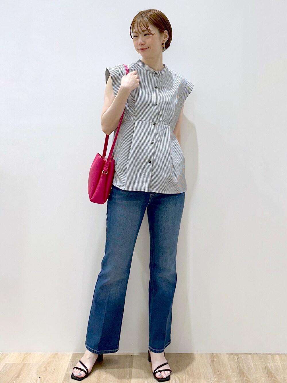 ホワイト系のシャツ/ブラウス、ブルー系のデニムパンツ、ピンク系のショルダーバッグを着用したレディースの夏コーディネートの6枚目の写真
