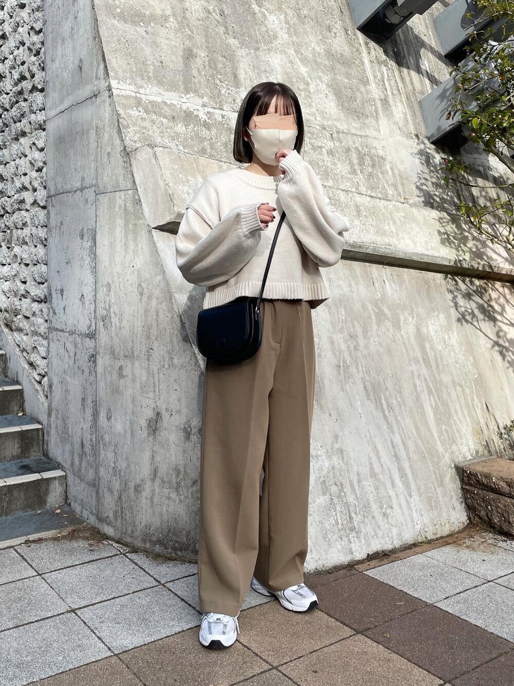 ベージュ系のニット/セーター、ベージュ系のその他パンツ、ブラック系のショルダーバッグを着用したレディースの冬コーディネートの2枚目の写真