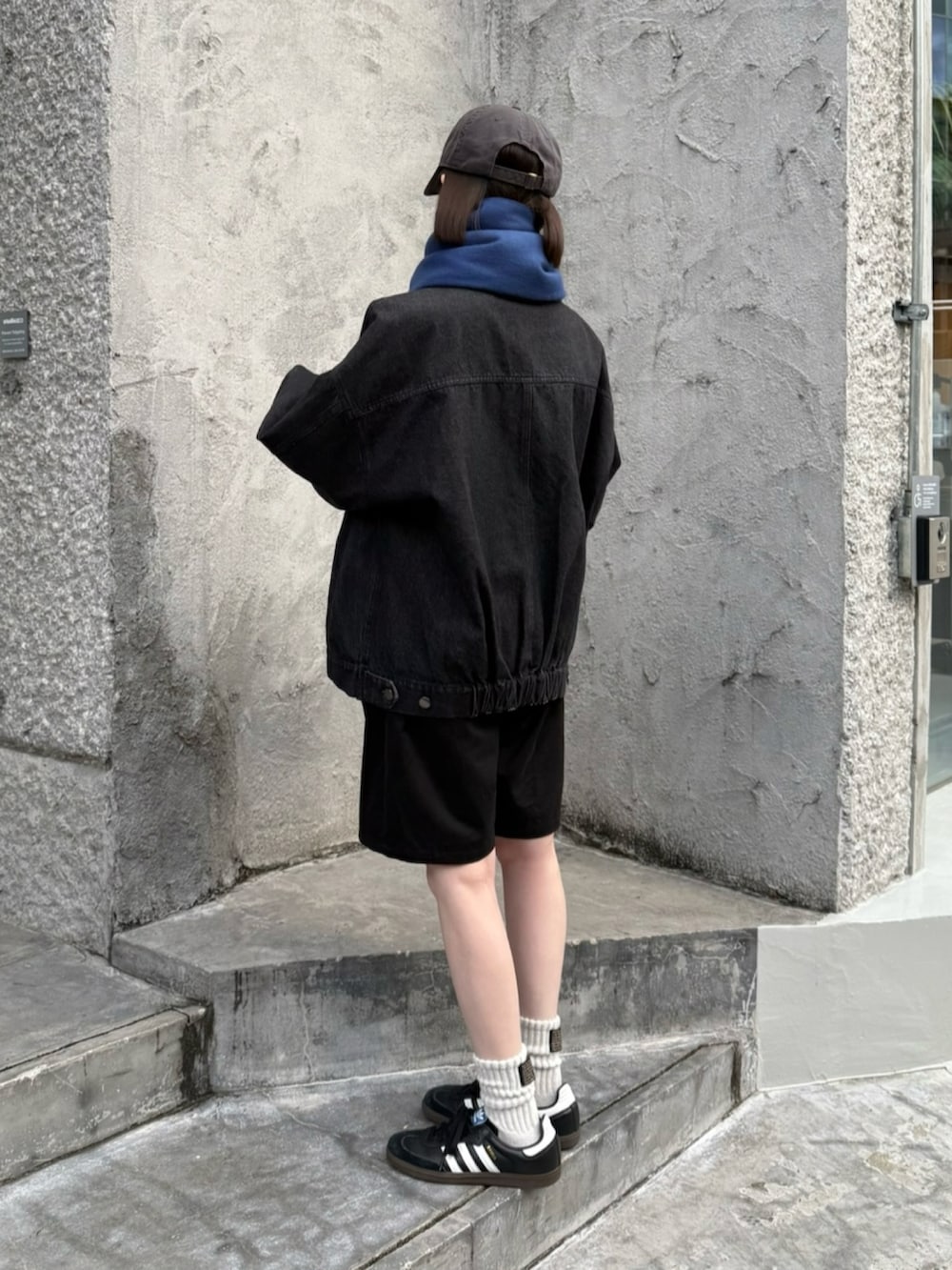 ブラック系のデニムジャケット、ブラック系のその他パンツ、ブラック系のスニーカーを着用したレディースの秋コーディネートの2枚目の写真