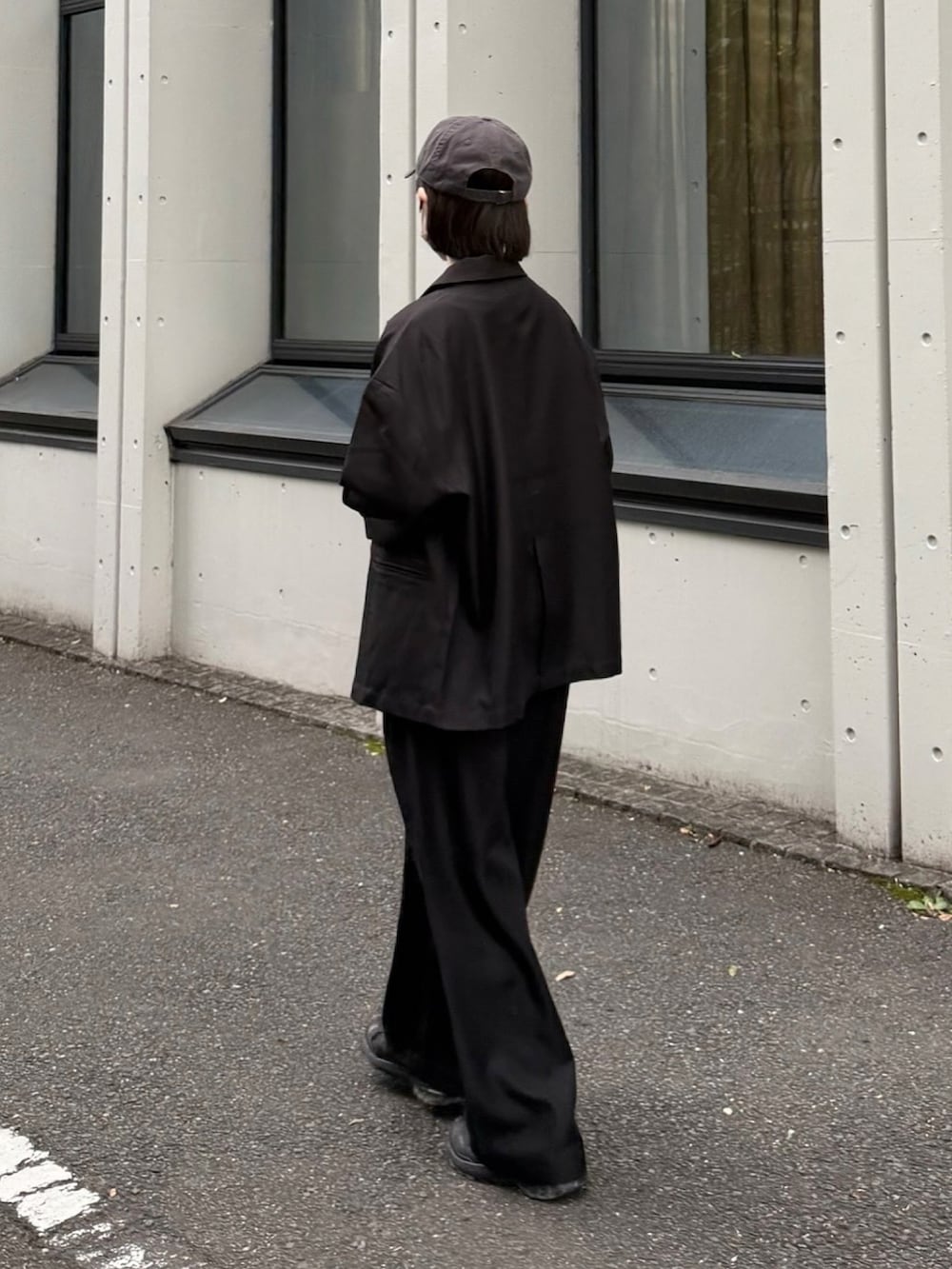 グレー系のTシャツ/カットソー、ブラック系のテーラードジャケット、ブラック系のスニーカーを着用したレディースの秋コーディネートの3枚目の写真