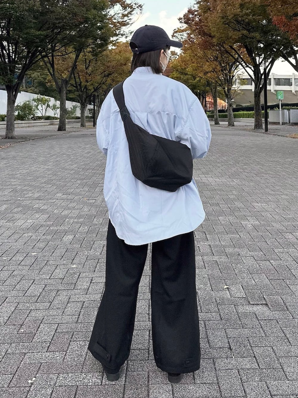 ブルー系のシャツ/ブラウス、ブラック系のスラックス、ブラック系のシューズを着用したレディースの秋コーディネートの2枚目の写真