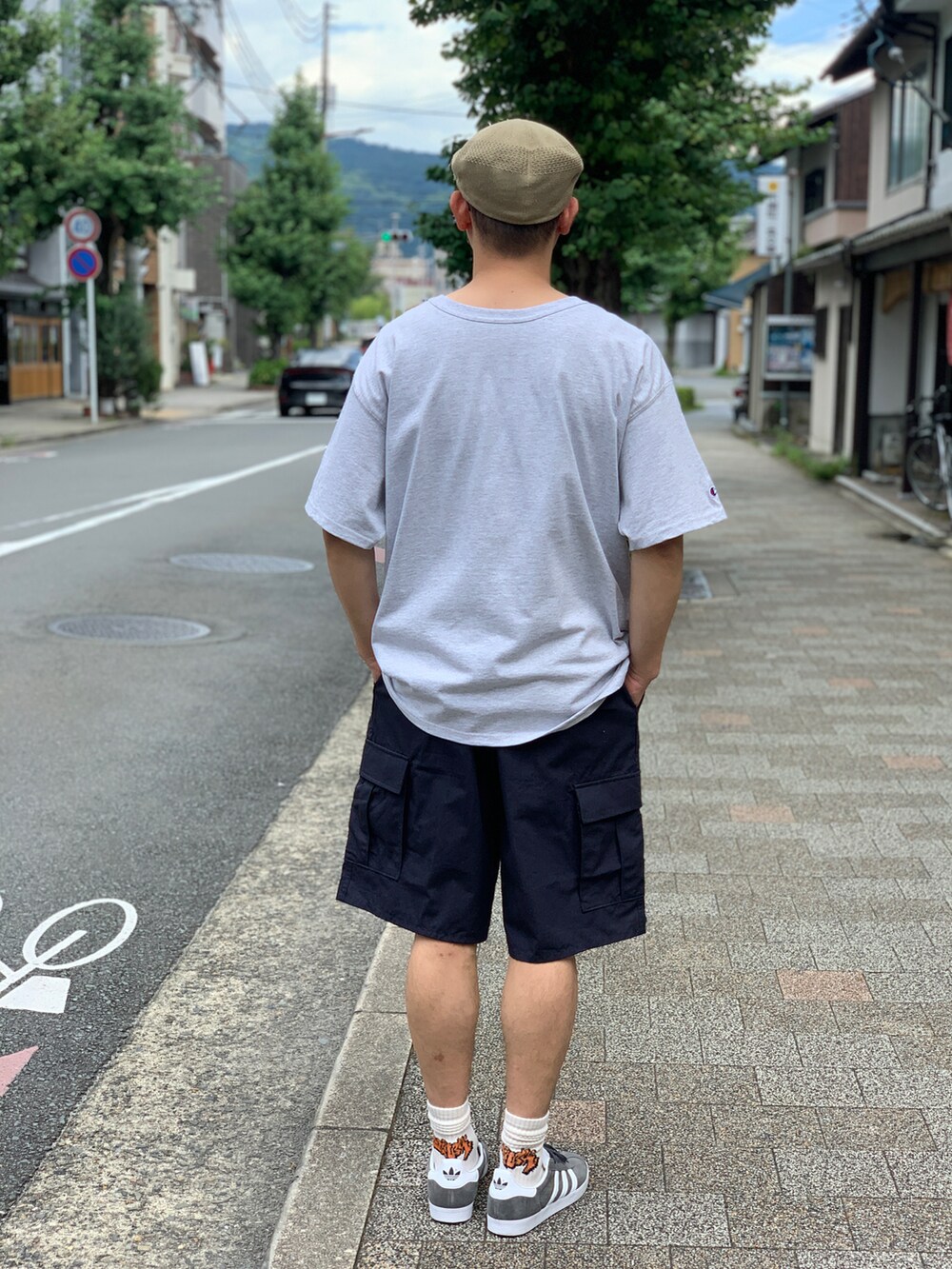 ベージュ系のTシャツ/カットソー、ブルー系のカーゴパンツを着用したメンズの夏コーディネートの5枚目の写真