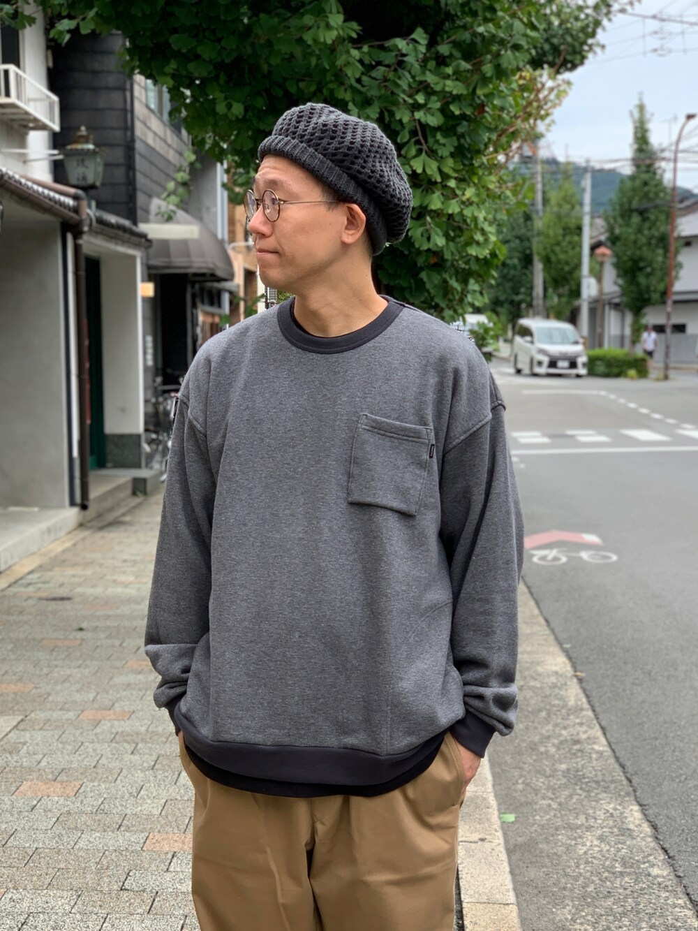 ベージュ系のチノパンツ、グレー系のスウェット、グレー系のニットキャップ/ビーニーを着用したメンズの秋コーディネートの3枚目の写真