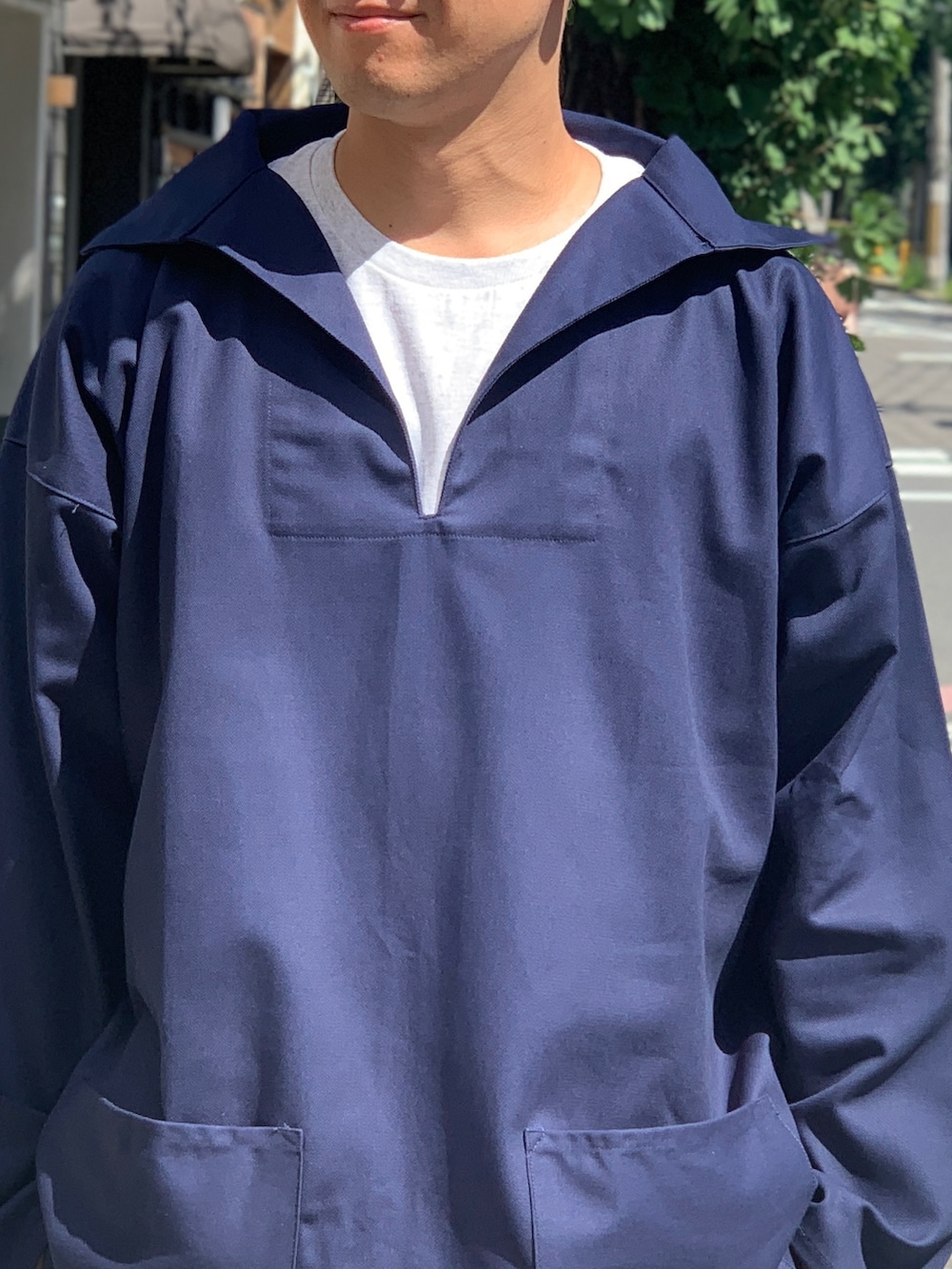 ベージュ系のチノパンツ、ブルー系のジャケット/アウター、ブラック系のスニーカーを着用したメンズの秋コーディネートの5枚目の写真