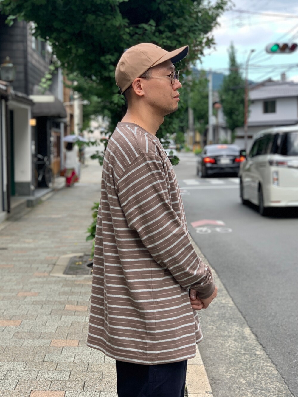 ブルー系のチノパンツ、ブラウン系のTシャツ/カットソーを着用したメンズの秋コーディネートの3枚目の写真