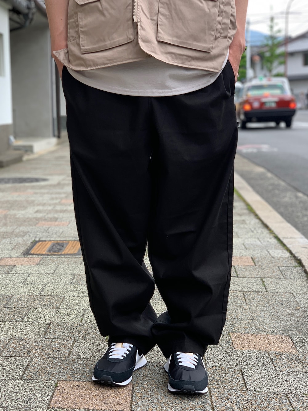 ブラック系のその他パンツ、ベージュ系のその他アウターを着用したメンズの春コーディネートの5枚目の写真