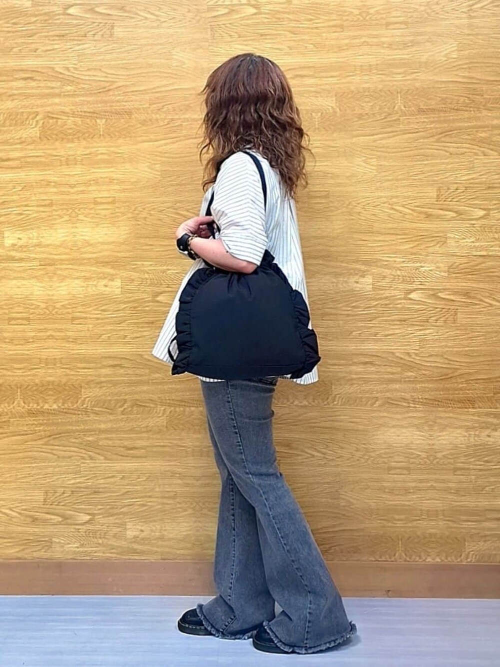 ベージュ系のシャツ/ブラウス、ブラック系のデニムパンツ、ブラック系のトートバッグを着用したレディースの夏コーディネートの2枚目の写真