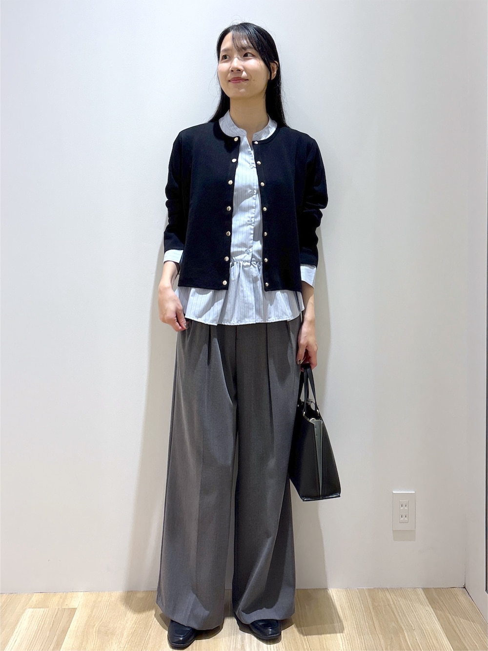 ブラック系のカーディガン/ボレロ、ブルー系のシャツ/ブラウス、グレー系のその他パンツを着用したレディースの秋コーディネートの9枚目の写真