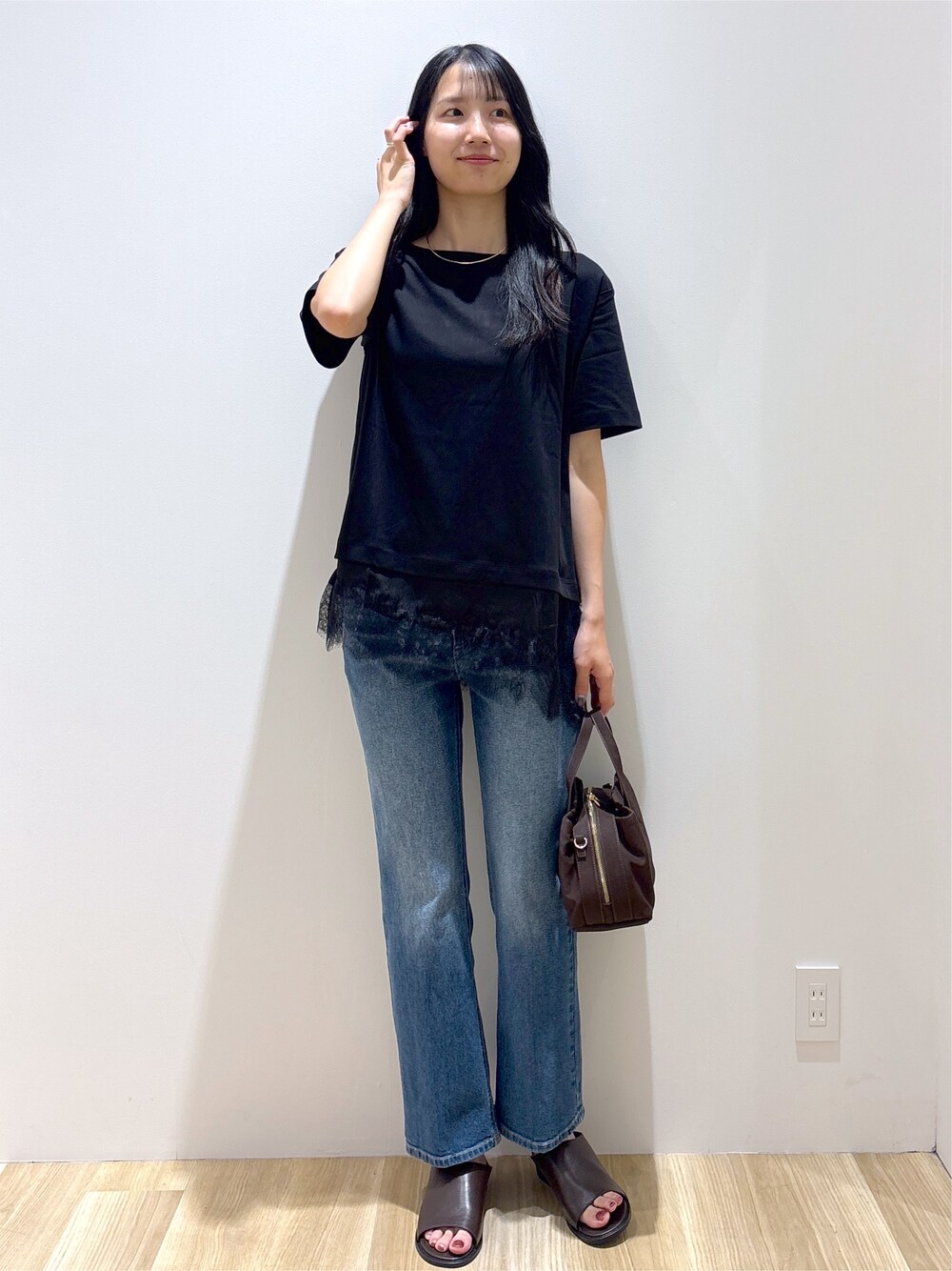 ブラック系のTシャツ/カットソー、ブルー系のデニムパンツ、ブラウン系のボストンバッグを着用したレディースの夏コーディネートの8枚目の写真