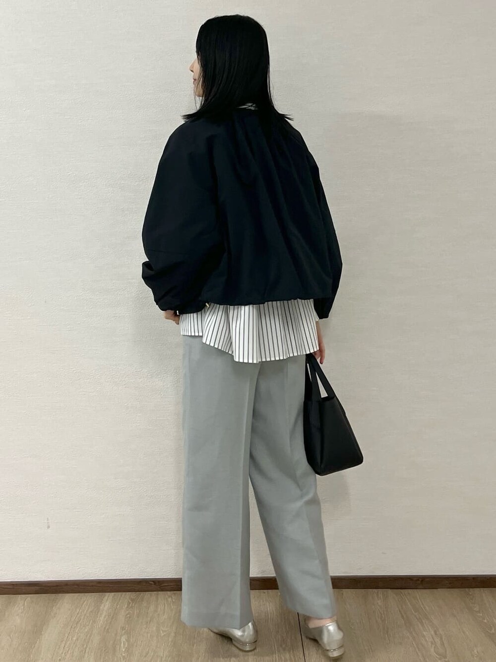 ブラック系のノーカラーコート、ホワイト系のシャツ/ブラウス、グレー系のその他パンツを着用したレディースの春コーディネートの4枚目の写真