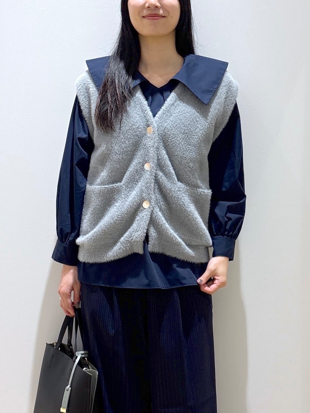 グレー系のニット/セーター、ブルー系のシャツ/ブラウス、ブルー系のその他パンツを着用したレディースの秋コーディネートの6枚目の写真