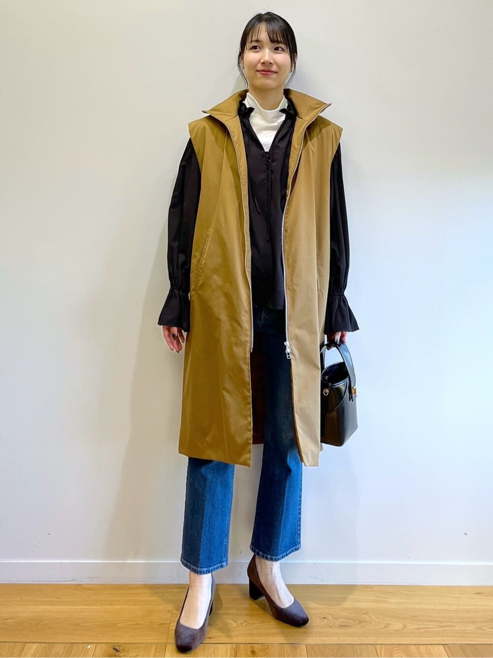 ブラック系のシャツ/ブラウス、ブルー系のデニムパンツ、グレー系のショルダーバッグを着用したレディースの冬コーディネートの7枚目の写真