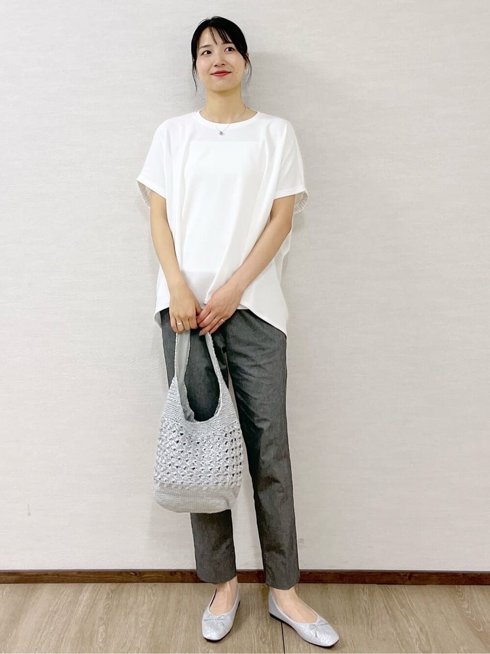 ホワイト系のTシャツ/カットソー、グレー系のその他パンツ、ブラック系のボストンバッグを着用したレディースの夏コーディネートの3枚目の写真