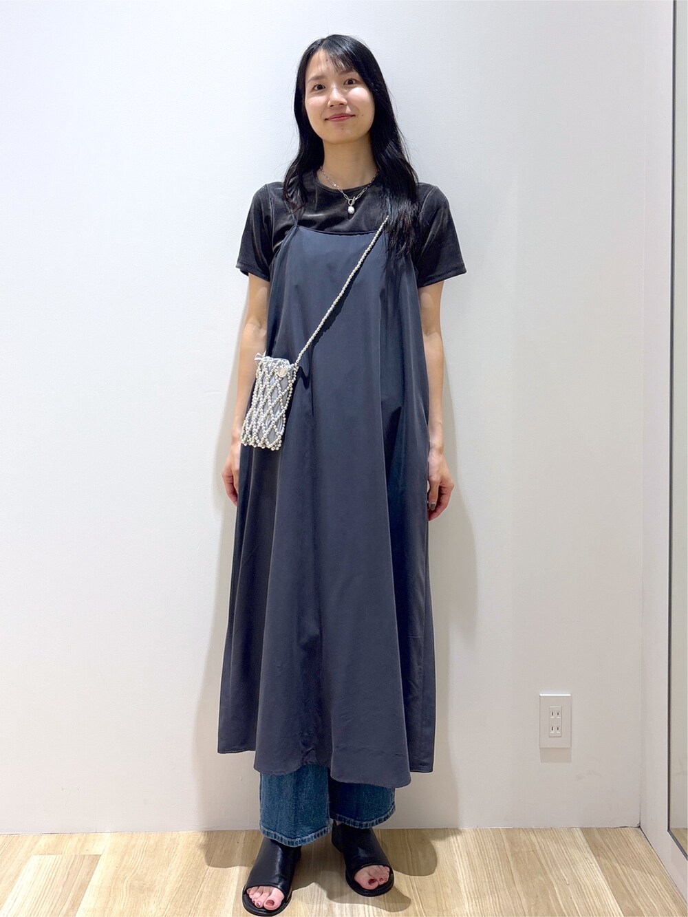 グレー系のワンピース、グレー系のTシャツ/カットソー、ブルー系のデニムパンツを着用したレディースの夏コーディネートの9枚目の写真