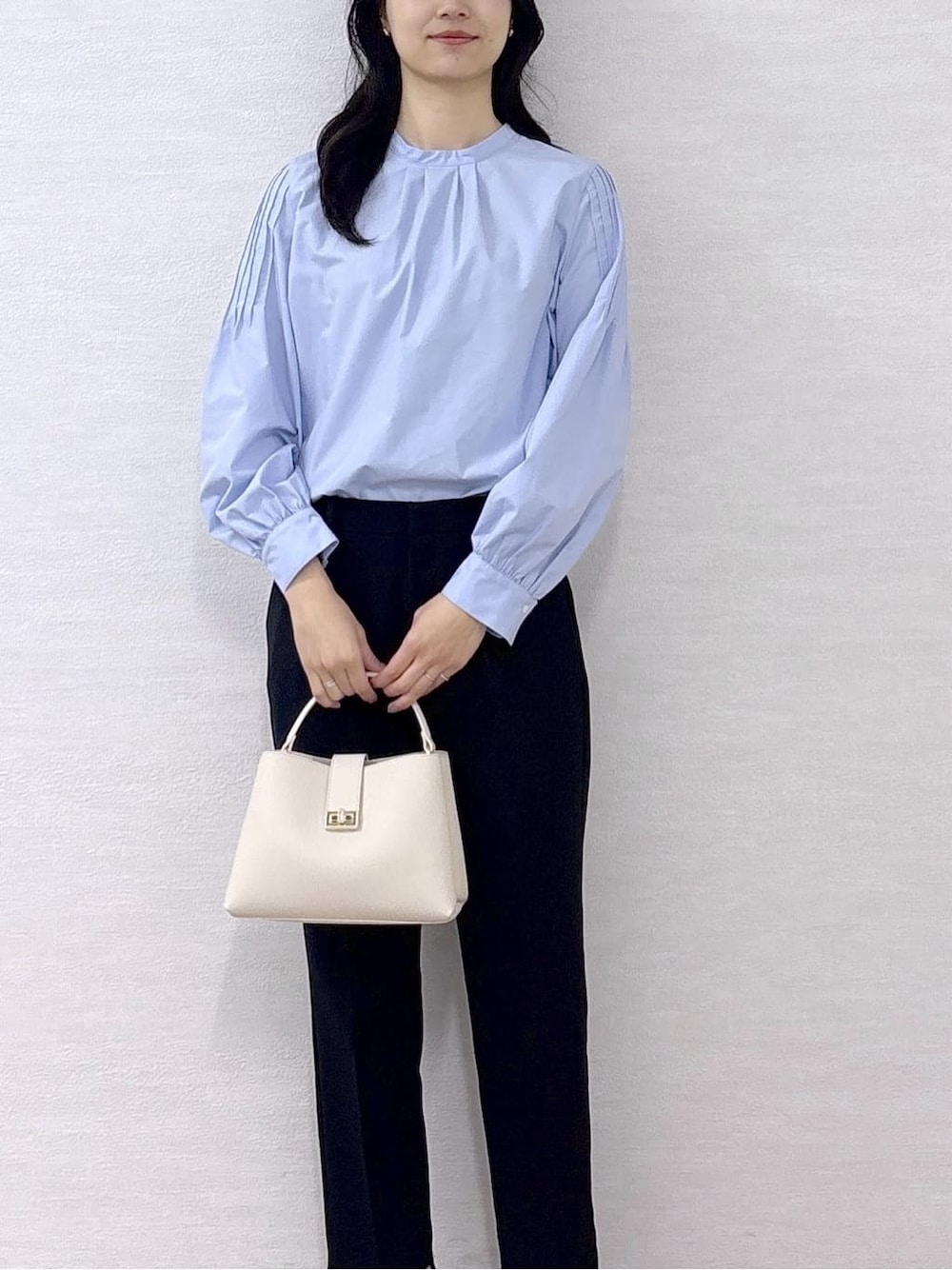 ブルー系のシャツ/ブラウス、ブラック系のその他パンツ、ホワイト系のハンドバッグを着用したレディースの冬コーディネートの7枚目の写真