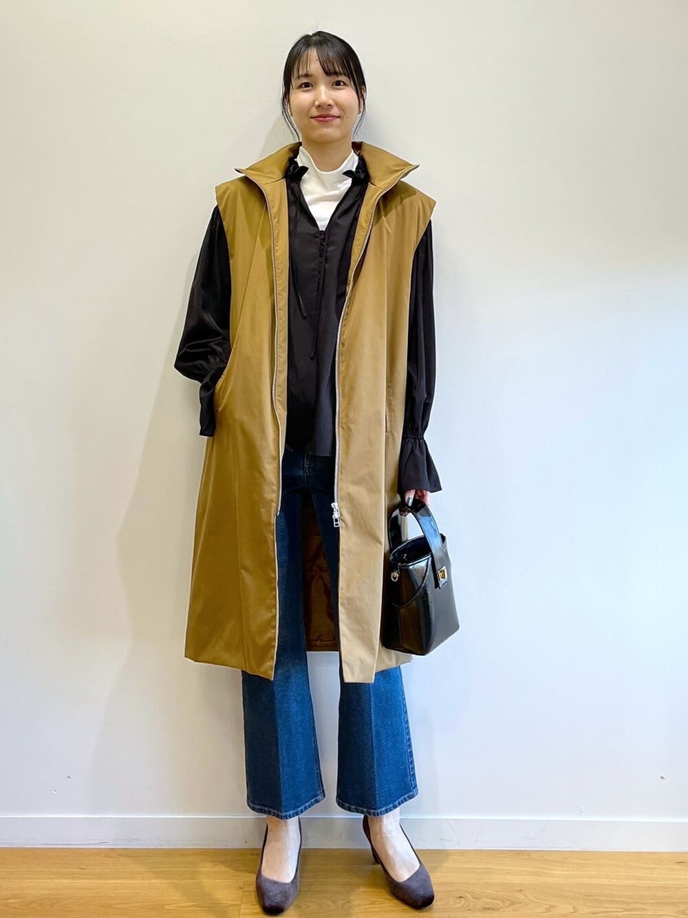 ブラック系のシャツ/ブラウス、ブルー系のデニムパンツ、グレー系のショルダーバッグを着用したレディースの冬コーディネートの6枚目の写真