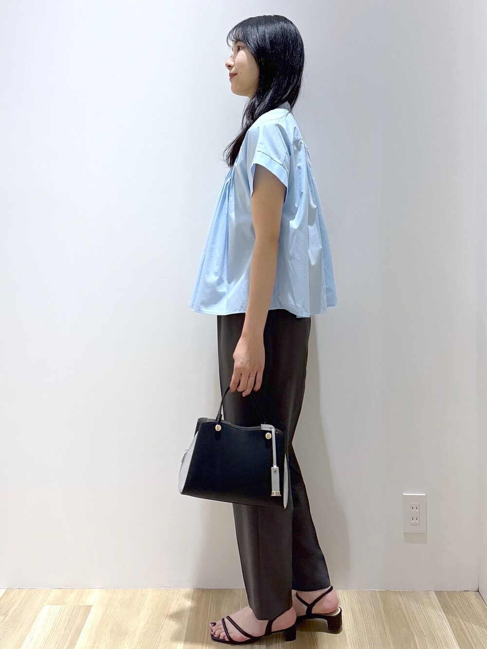 ブルー系のシャツ/ブラウス、グレー系のその他パンツ、ブラック系のショルダーバッグを着用したレディースの夏コーディネートの3枚目の写真