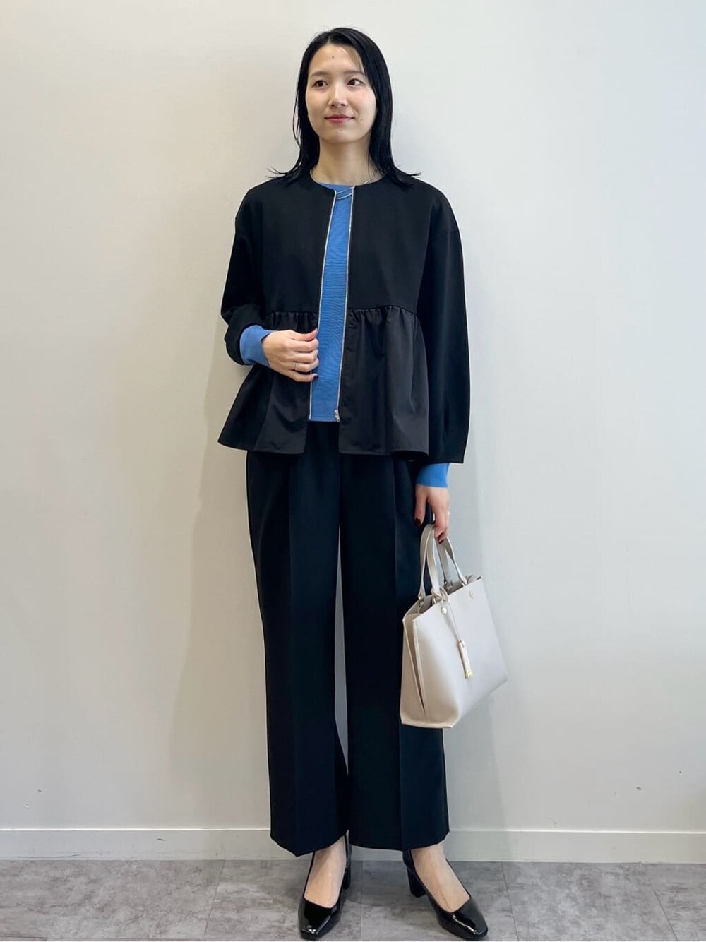 ブラック系のカーディガン/ボレロ、ブルー系のニット/セーター、ブラック系のその他パンツを着用したレディースの春コーディネートの2枚目の写真