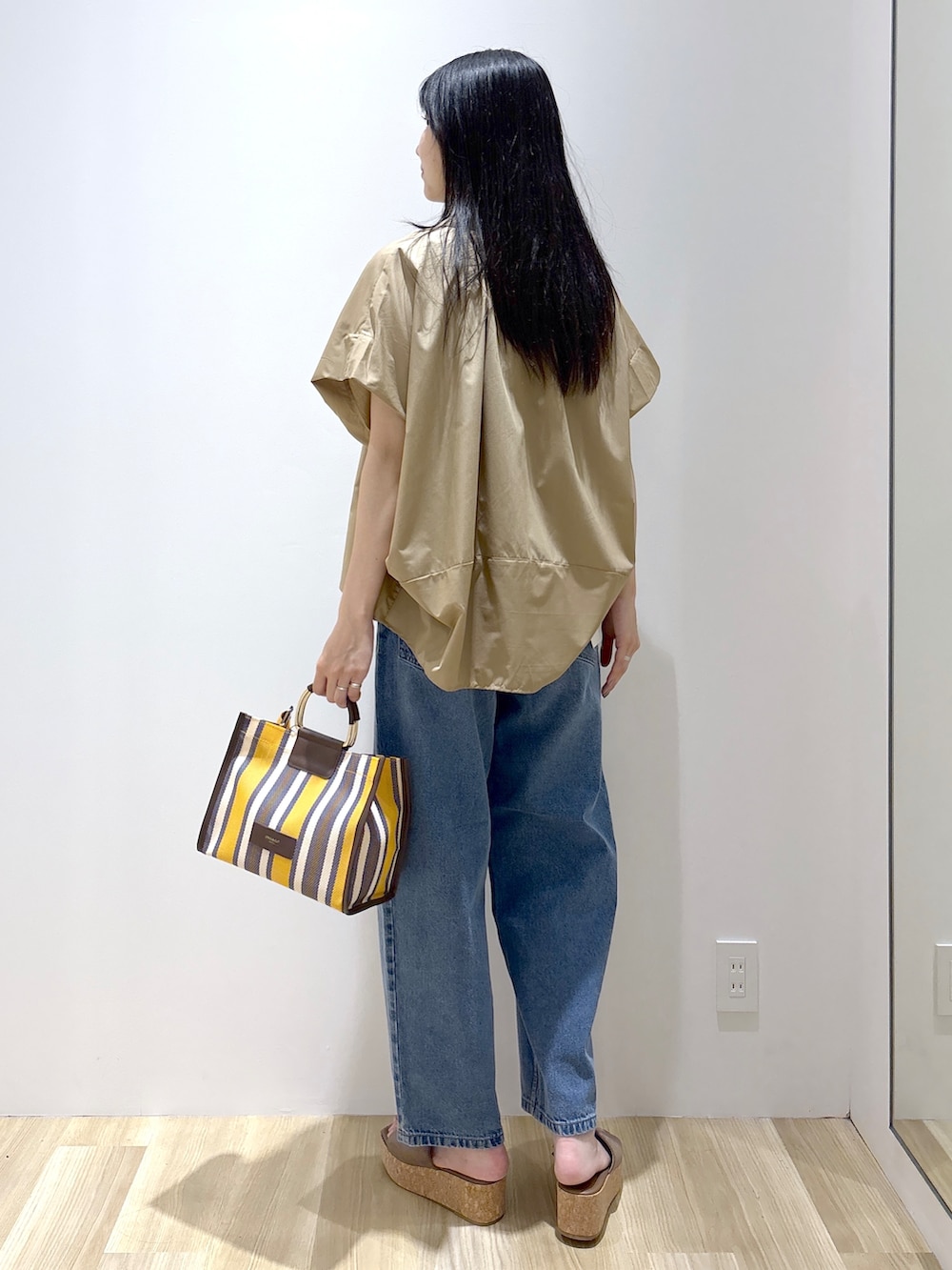 ベージュ系のシャツ/ブラウス、ブラック系のタンクトップ、ブルー系のデニムパンツを着用したレディースの夏コーディネートの4枚目の写真