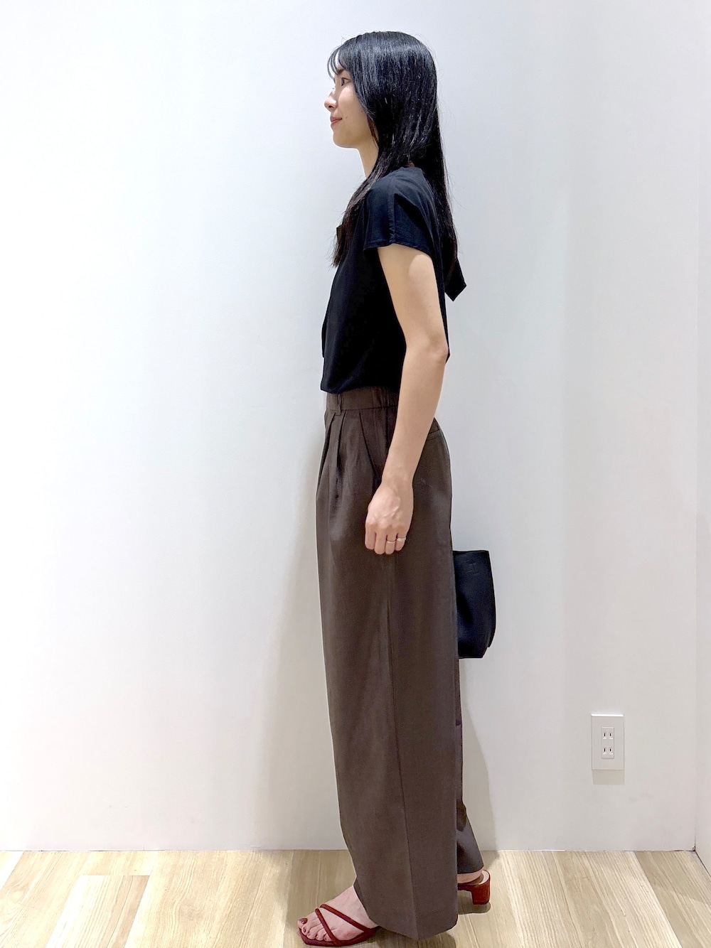 ブラック系のTシャツ/カットソー、ブラウン系のその他パンツ、ブラウン系のトートバッグを着用したレディースの夏コーディネートの3枚目の写真