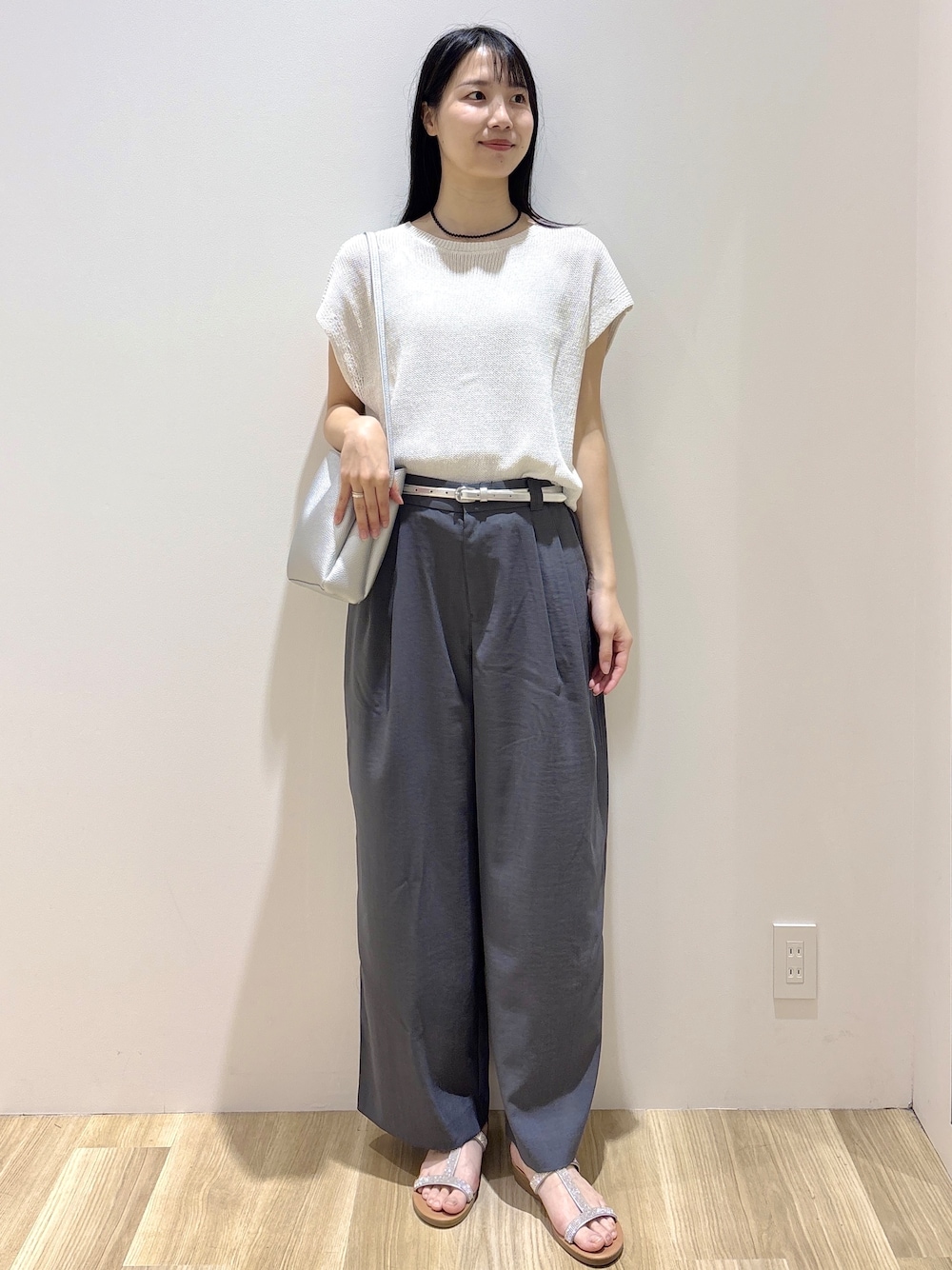 ホワイト系のニット/セーター、グレー系のその他パンツ、シルバー系のショルダーバッグを着用したレディースの夏コーディネートの10枚目の写真