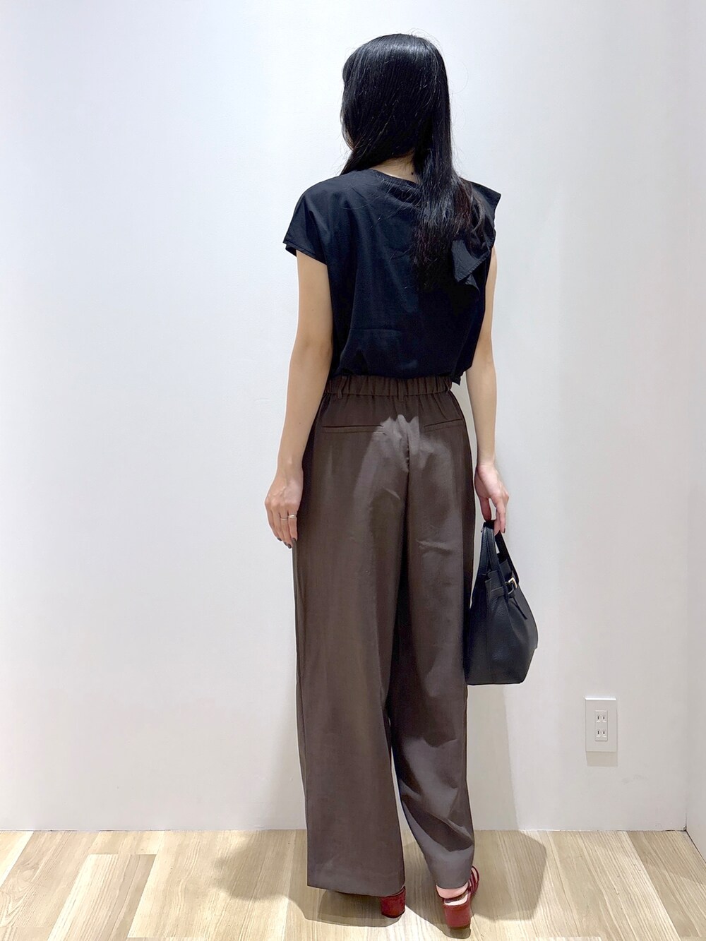 ブラック系のTシャツ/カットソー、ブラウン系のその他パンツ、ブラウン系のトートバッグを着用したレディースの夏コーディネートの4枚目の写真