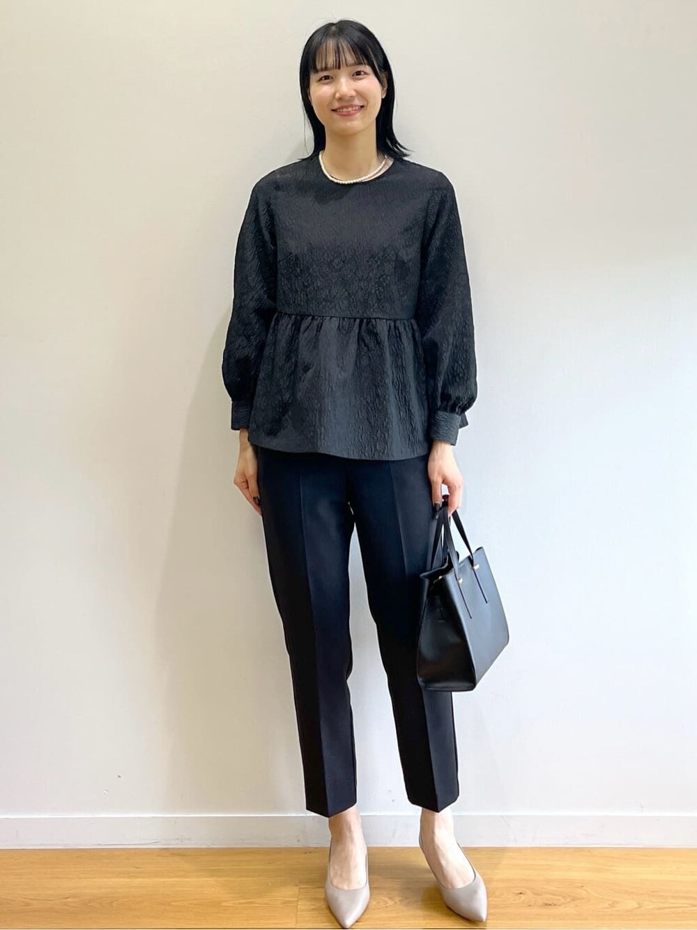 ホワイト系のノーカラーコート、ブラック系のシャツ/ブラウス、ブラック系のその他パンツを着用したレディースの冬コーディネートの10枚目の写真
