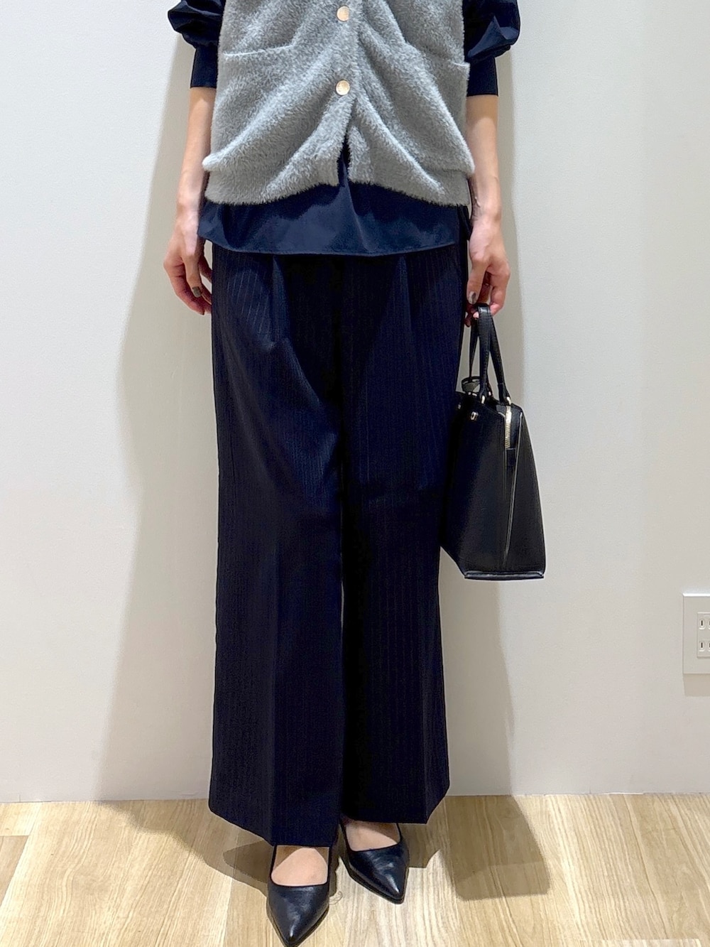 グレー系のニット/セーター、ブルー系のシャツ/ブラウス、ブルー系のその他パンツを着用したレディースの秋コーディネートの7枚目の写真