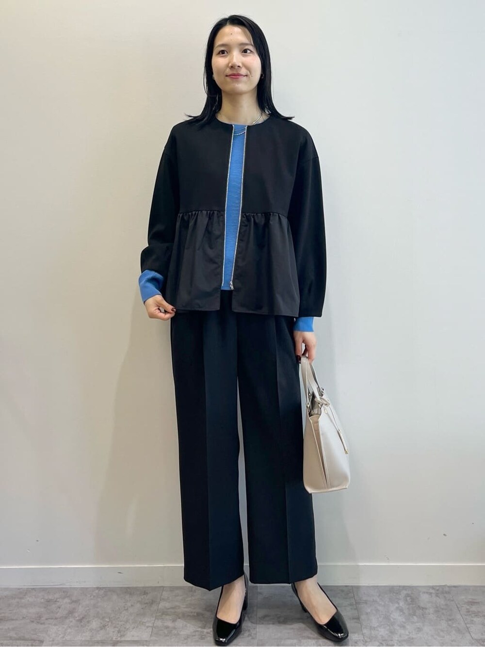 ブラック系のカーディガン/ボレロ、ブルー系のニット/セーター、ブラック系のその他パンツを着用したレディースの春コーディネートの10枚目の写真