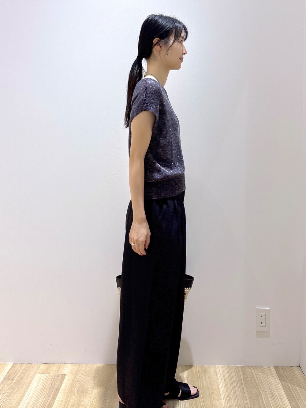 グレー系のニット/セーター、ブラック系のその他パンツ、ブラック系のトートバッグを着用したレディースの夏コーディネートの5枚目の写真