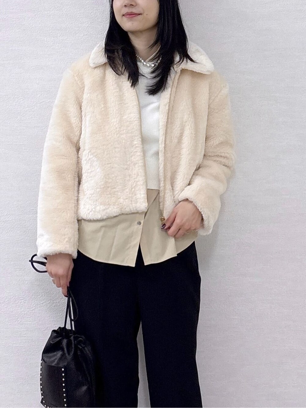 ホワイト系のブルゾン、ホワイト系のニット/セーター、ベージュ系のシャツ/ブラウスを着用したレディースの冬コーディネートの7枚目の写真